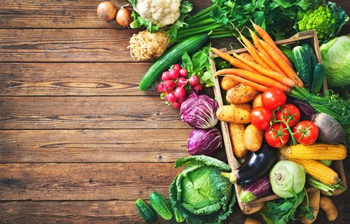 wood table with fresh vegetables on top