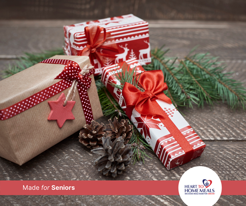 three Christmas presents wrapped with bows and pinecones