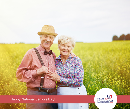 senior man and senior women standing in farm field smiling