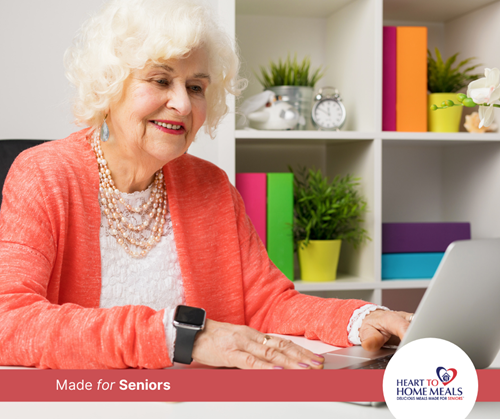 Well dressed senior lady working on a MacBook laptop