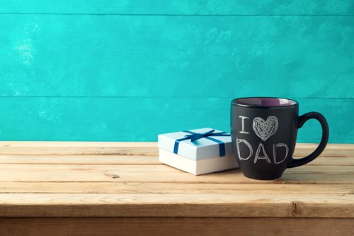 wood table with a coffee mug that reads I love dad